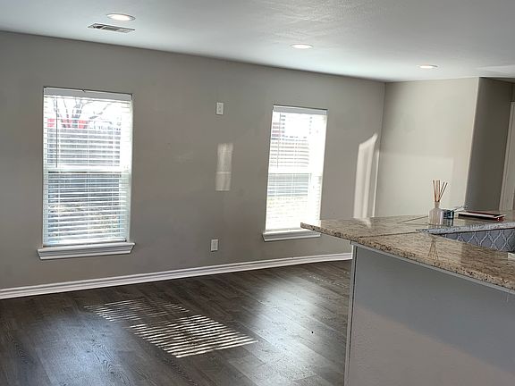 Open concept kitchen, dining and den. Beautiful granite countertops and new flooring.