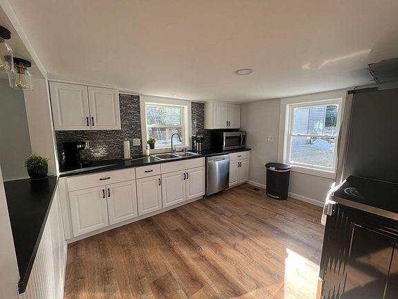 Brand new kitchen with stainless appliances and hardwoods is a perfect place to prepare a delicious meal.