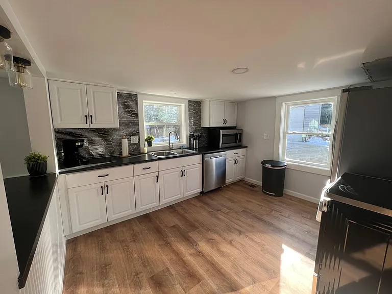 Brand new kitchen with stainless appliances and hardwoods is a perfect place to prepare a delicious meal.