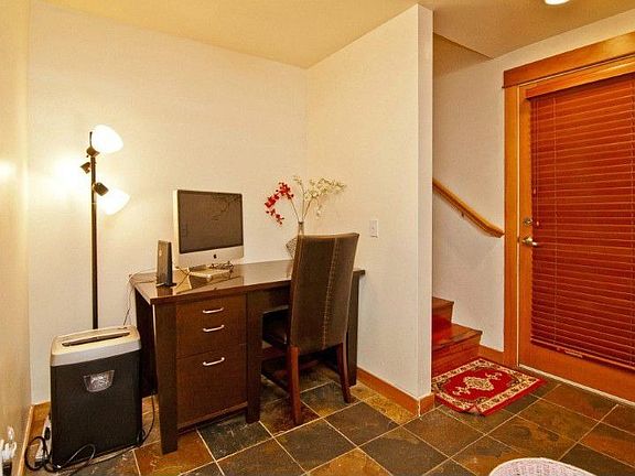 Formal slate entry way with nook perfect for home office. Door leads to back and side yard.