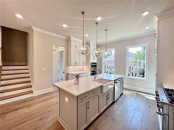 Home Site 19 Willow Gray cabinets with 3 glass globe pendants