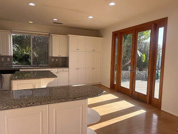 Kitchen with french doors that lead to backyard