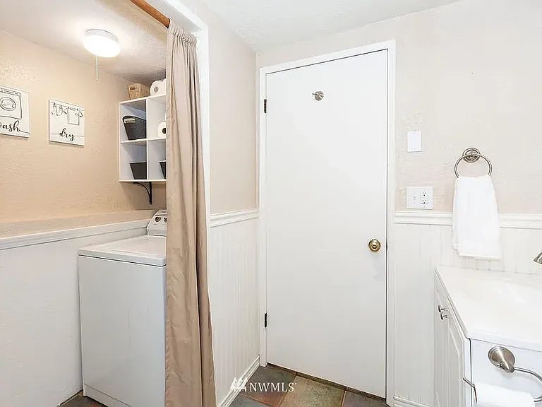 First Floor Bathroom and Laundry Area (Photo from Previous Listing)