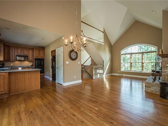 Dining room open to the kitchen..notice the soaring ceilings and catwalk of the second level.