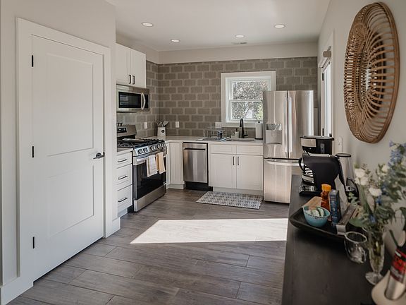 Full kitchen with a microwave, stove, oven, dishwasher, and refrigerator