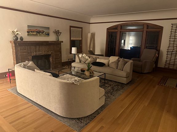 Large living room with super comfy sofas, great art & fireplace . . . leads into dining room