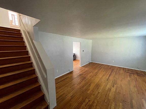 stairs, dining room entrance in the middle and rest of living room