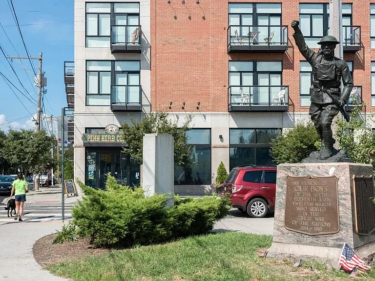 Up the street from the building is soldier's statute which is adjacent to the SEPTA line