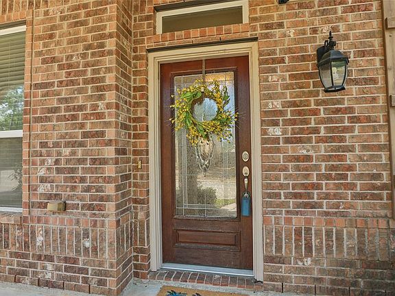 WELCOMING FRONT DOOR: This handsome hardwood door with leaded glass inserts sets the tone for this move-in ready home.