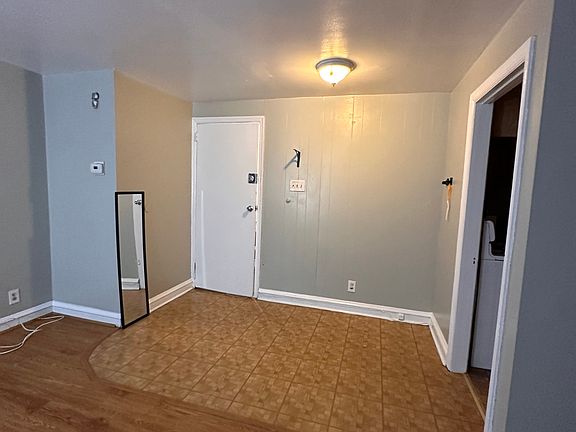 foyer by main entrance. Walls are a light gray, ceiling, baseboards and doors are white!