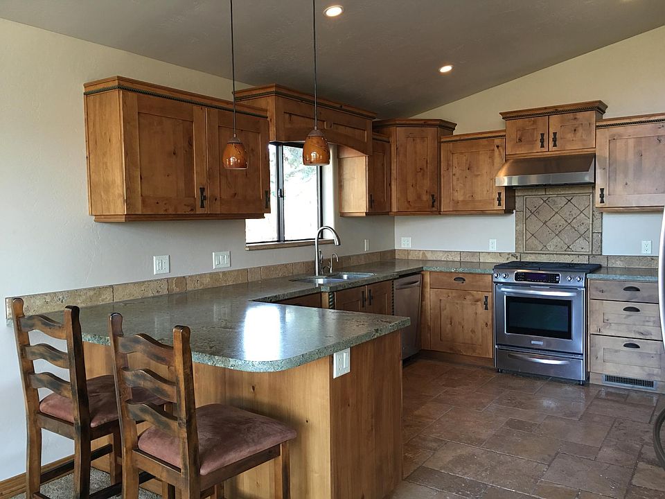 Custom Kitchen, Knotty Alder cabinets, travertine floors and
