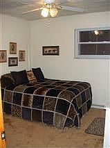 One of three bedrooms featuring double pane windows, custom vertical blinds an