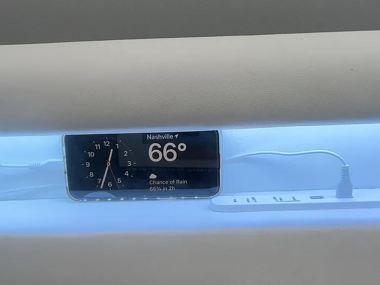King platform headboard has a convenient charging setup.