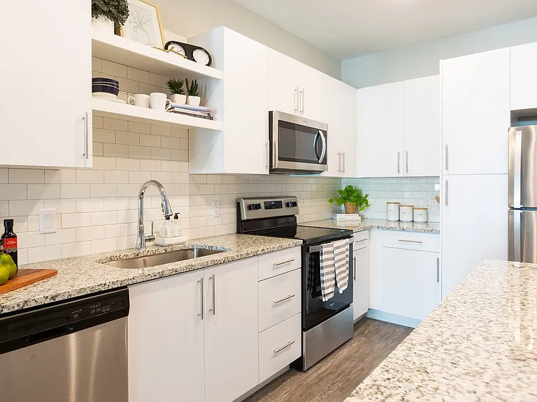Open-concept kitchens feature stainless steel appliances.