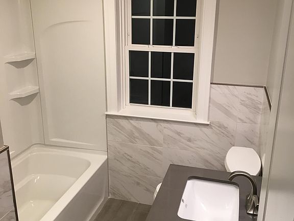Renovated lower level bathroom. Features shower/tub surroun