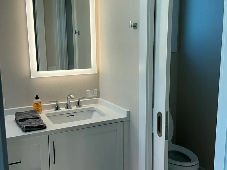 Double sinks and privacy en suite bath in primary bedroom