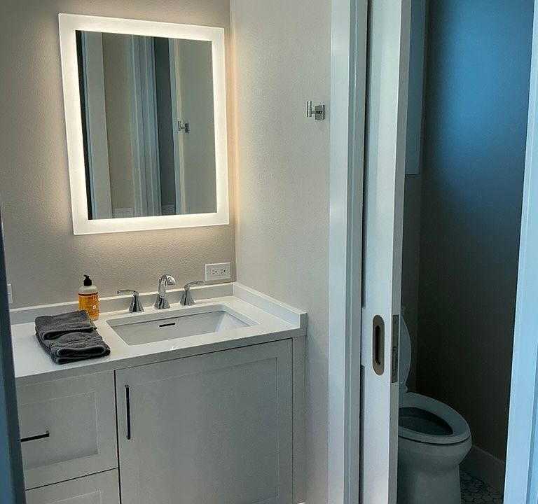 Double sinks and privacy en suite bath in primary bedroom