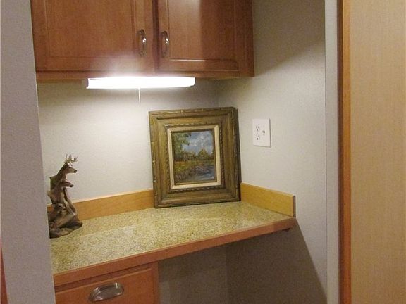 This desk space is directly across from the kitchen and a good landing spot as you enter your new home.