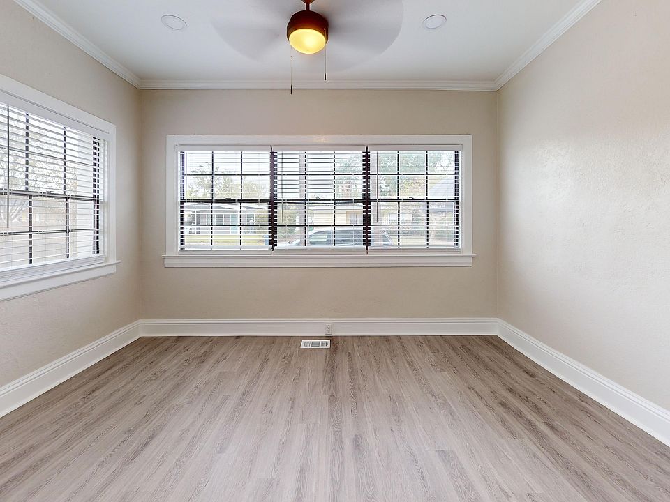 Experience the airy ambiance of this room, featuring elegant wood flooring and abundant natural light.