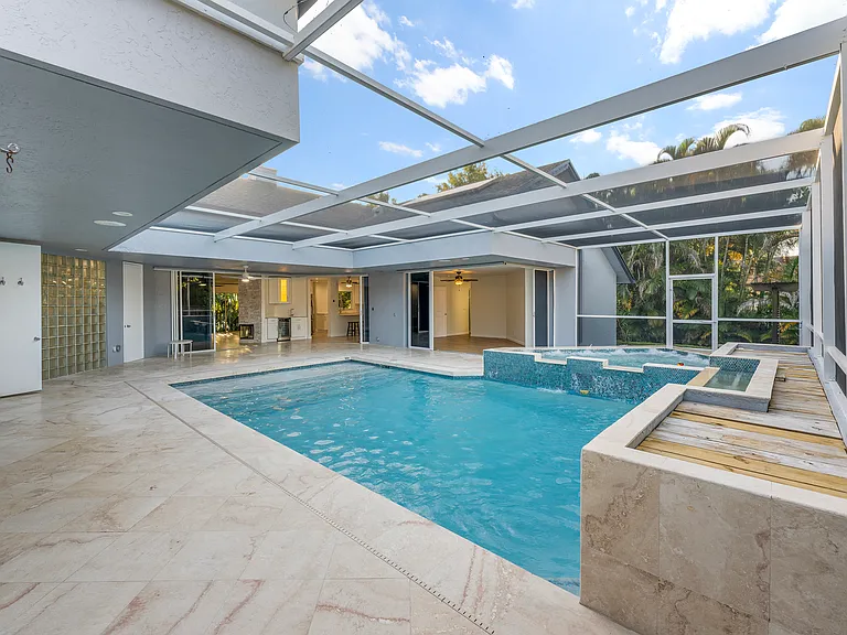 Screened pool and spa surrounded by the home