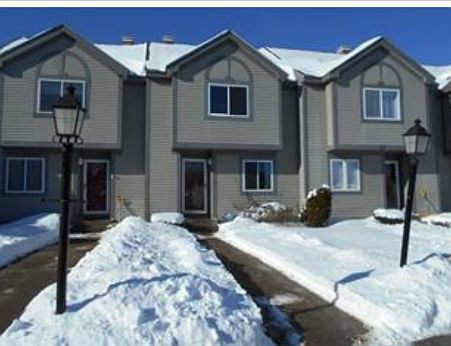 Front of house. Second from left