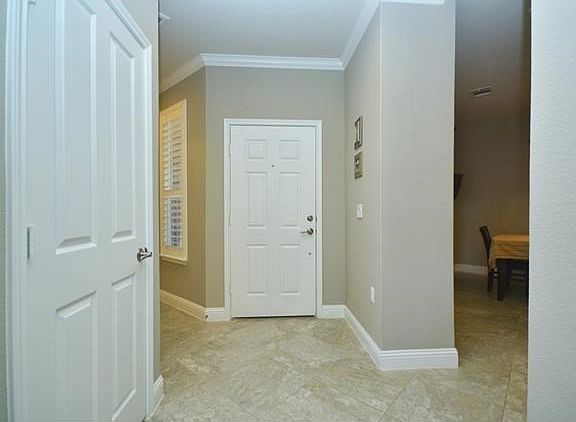 Crown molding and plantation shutters welcome you inside this delightful home.
