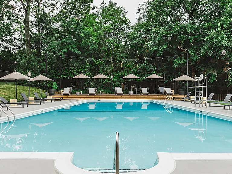 Beautifully reimagined pool and sundeck featuring brand new chaise lounges and umbrellas