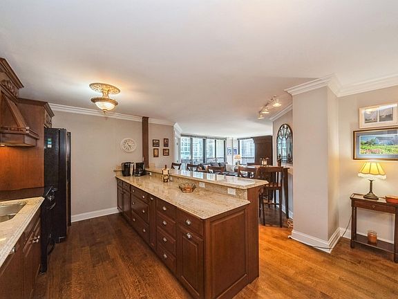 Kitchen with breakfast bar and cherry cabinetry.