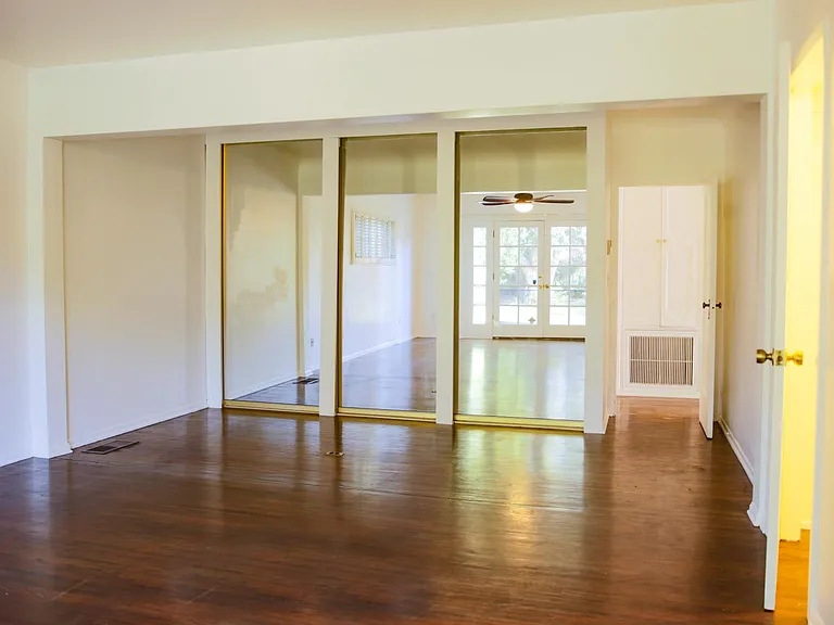 Master Bedroom 3 panel floor to ceiling mirror walk in closet. Door on right leads to a second walk in closet.