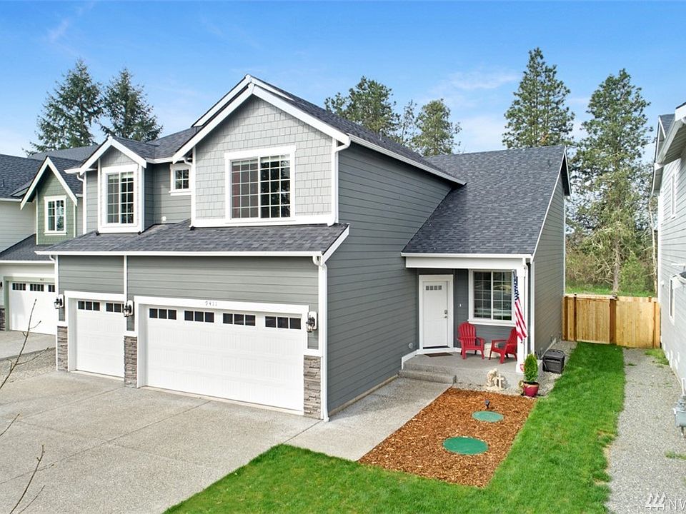 Front of house view with 3 car garage.  