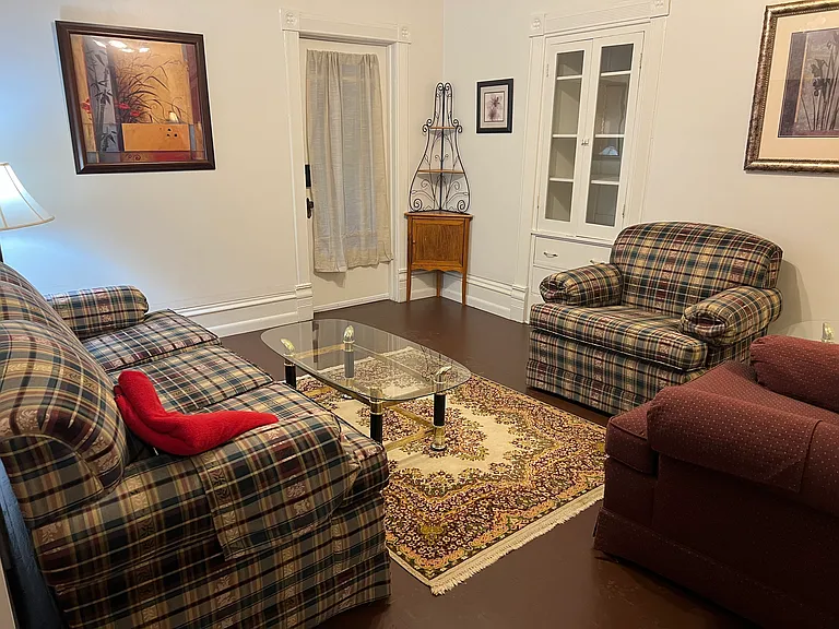 Living room, with back door out to shared hallway with laundry.
