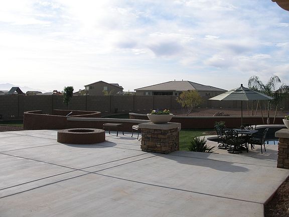 View of huge patio, firepit, resort landscaping