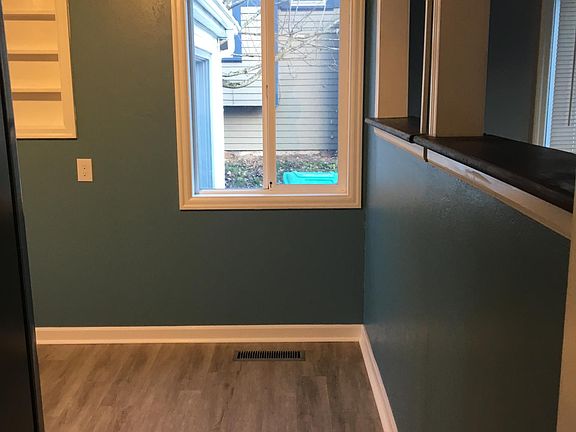 Kitchen entrance, new beautiful flooring. All new fresh paint. Open walls that look through to the living room.