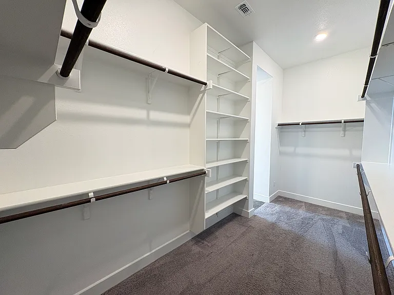 Huge walk in closet with floor to ceiling shelving