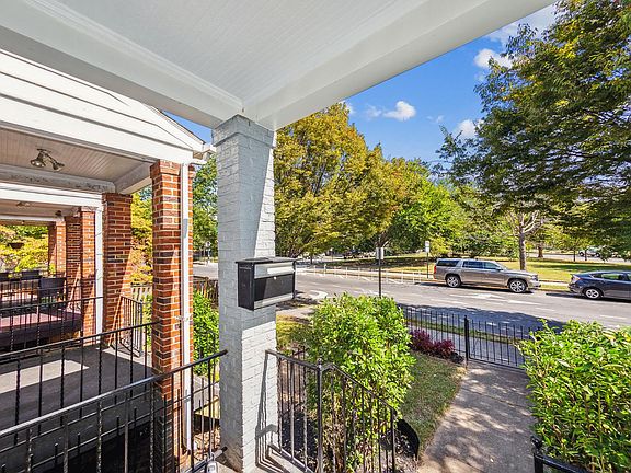 One way tree lined street with gated front yard