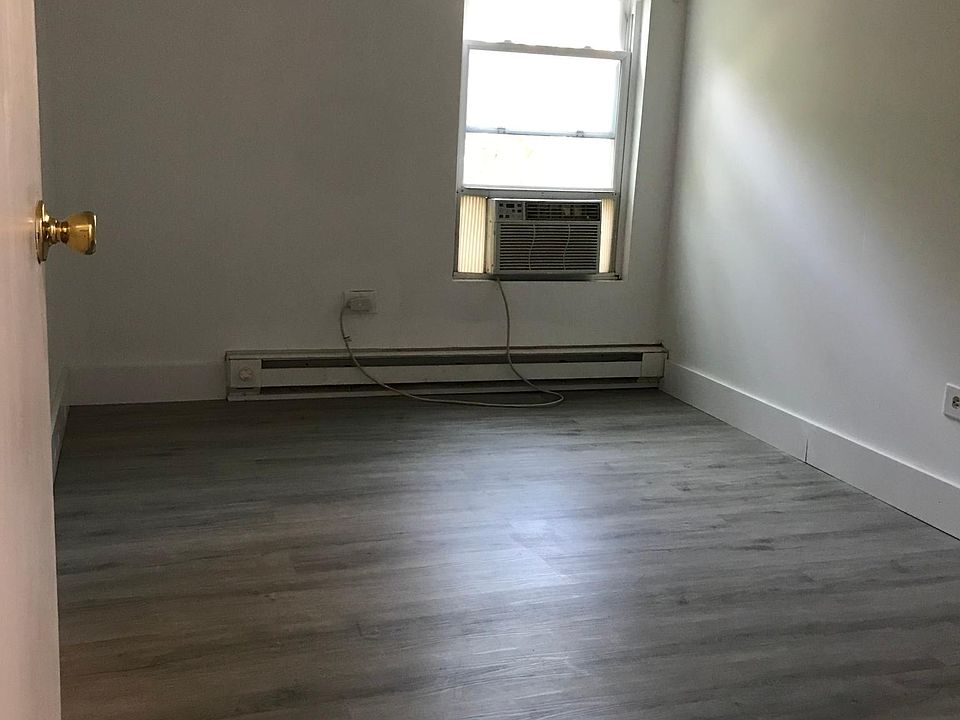Bedroom 1 of 2 with closet and AC unit