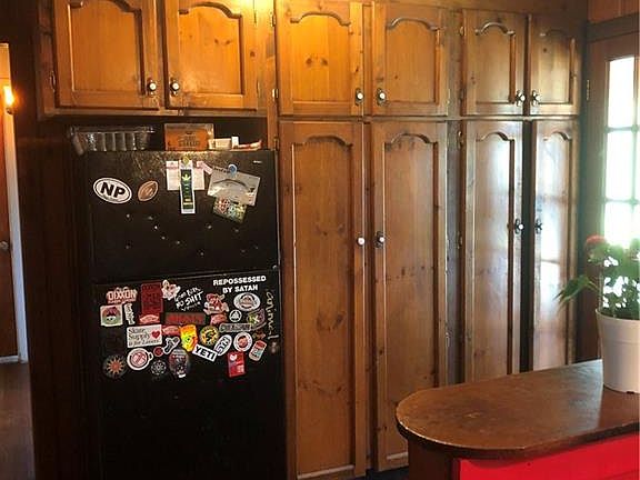 Rear exterior. Three sets of fairly new sliders to the sunroom.