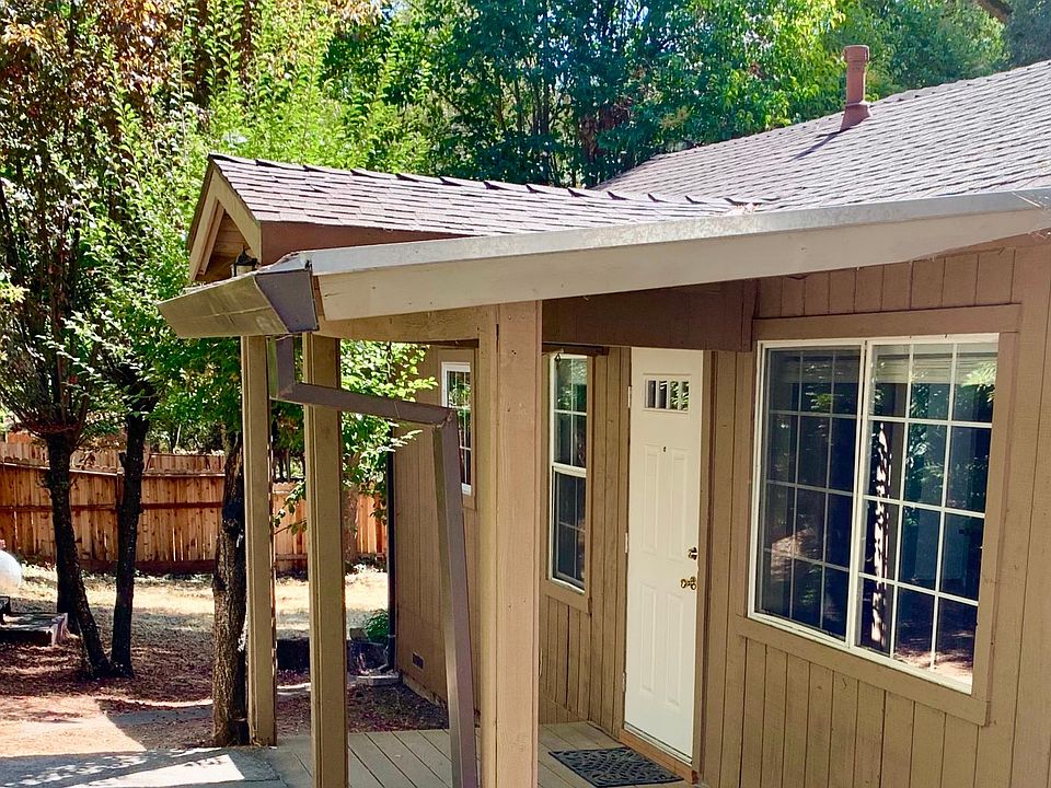 Front of house with covered deck.