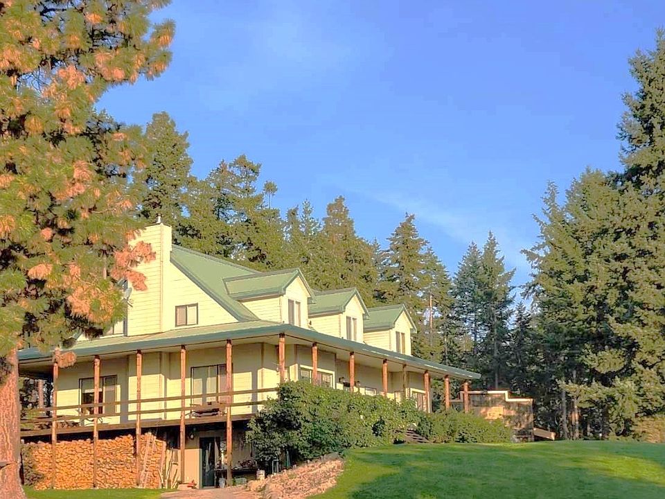 Welcome to 335 Elk Heights Dr.  20 acres of property consisting of mature growth evergreens, horse pastures, fenced corrals, outbuildings, manicured lawn and garden space as well as a stunning 4-bedroom/3 bath home with a wraparound porch, metal roof and unlimited storage space both inside and outside.  Book a showing today!>