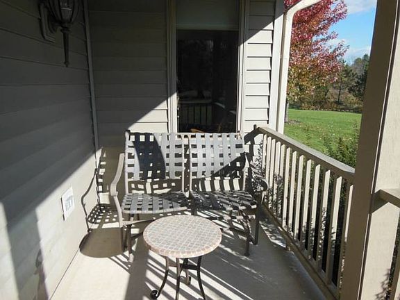 A sweet siting area on this small wrap around porch adds a bit of charm.