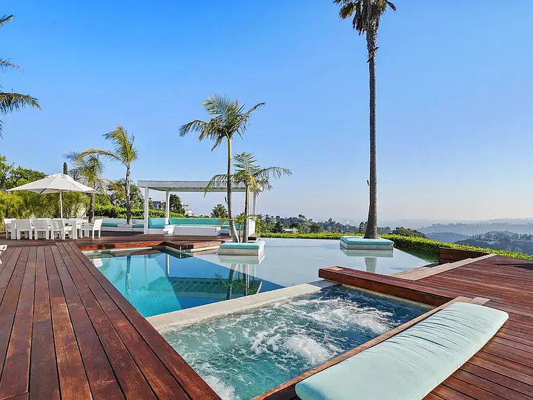 Indulge in pure relaxation as you soak in the hot tub attached to the inviting infinity pool.