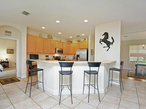 Kitchen breakfast bar with corona counter tops, 42" cabinets and