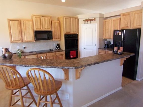 Kitchen features stunning upgraded hickory cabinets, pantry & lrge counter bar