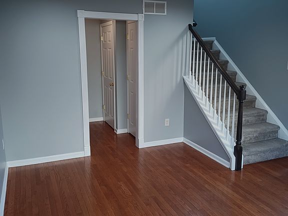 Living room, spacious coat closet and door to finished basement