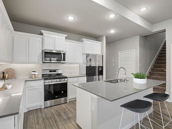 Kitchen in the Stanley home plan by Trophy Signature Homes - REPRESENTATIVE PHOTO