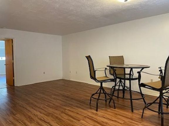 Large living room, dining combination. Easy to care for floors. View from front door.