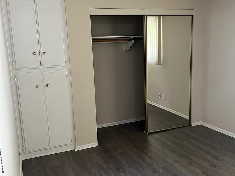 bedroom with mirrored wardrobe and storage