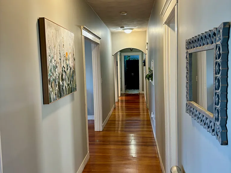 Hallway divides the living spaces with three bedrooms.