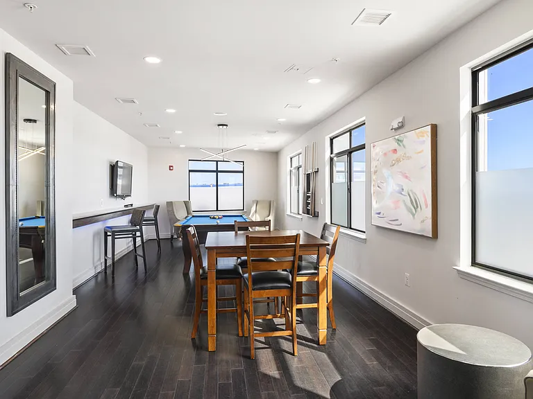 Exclusive resident lounge with kitchen, bar top, and billiards