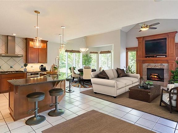 Bright open floor plan with walls of windows overlooking back yard. Relax next to the fire in beautiful hearth room.